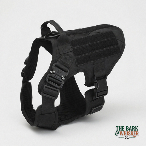 Black dog harness on a light gray background with 'The Bark & Whisker Co.' branding.